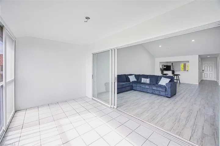Living room featuring lofted ceiling and light wood-type flooring