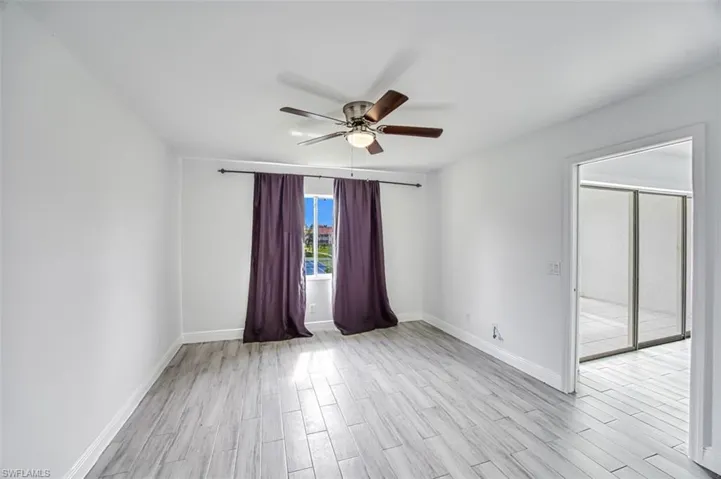 Spare room with ceiling fan and light wood-type flooring