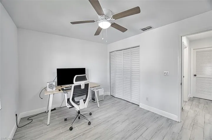 Home office featuring ceiling fan and light wood-type flooring