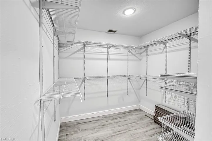 Walk in closet featuring wood-type flooring