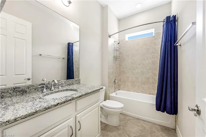 Guest Bath with granite countertops and tiled tub/shower area