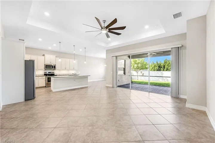 Great room living area with triple sliders leading out to your screened patio