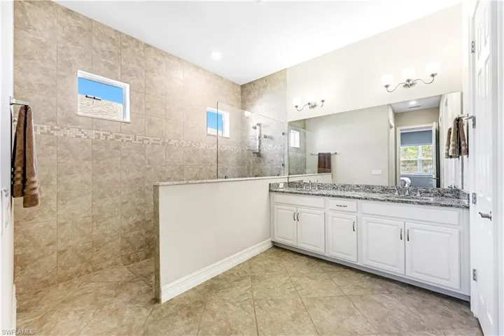 Master Bath with huge tiled walk in shower & dual vanities