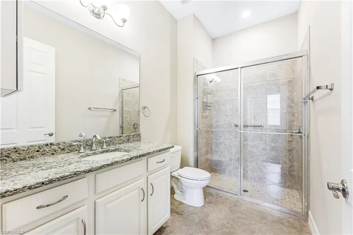 Guest Bath with walk in tiled shower & granite countertops