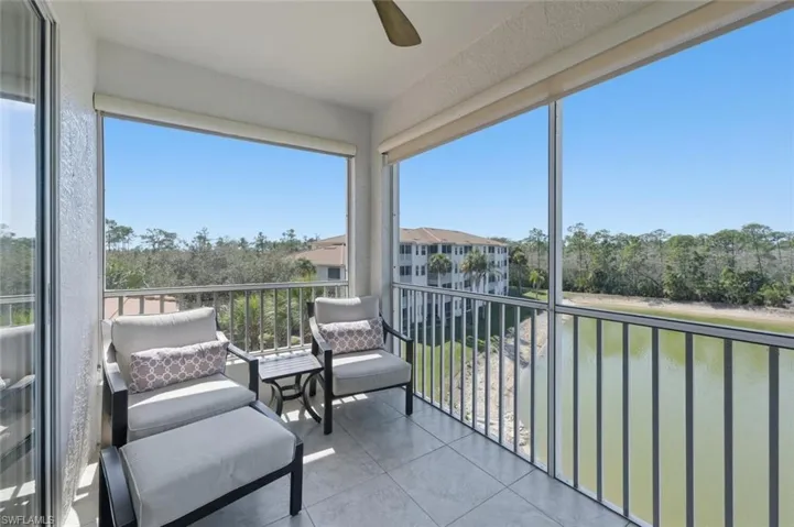 Sunroom / solarium featuring a water view and tile patterned flooring