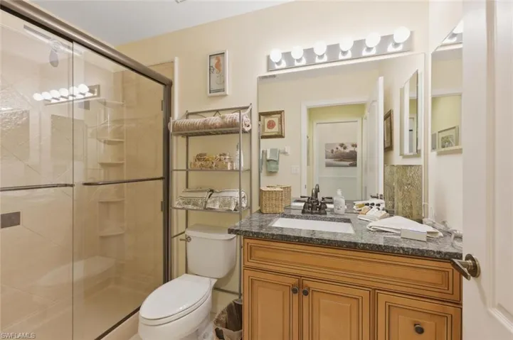 Full bathroom featuring vanity and a stall shower