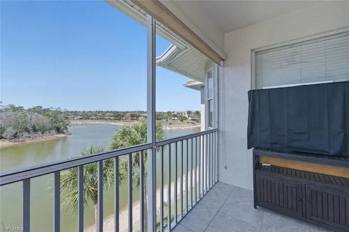 Balcony with a water view and a sunroom