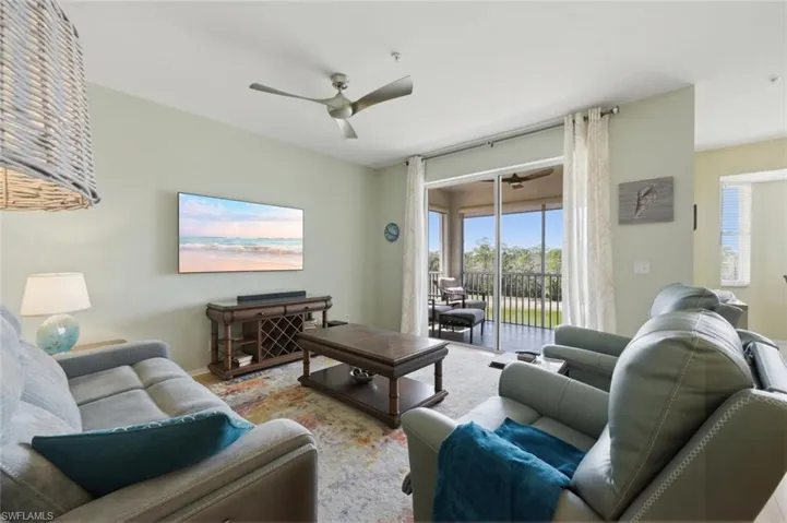Living area featuring healthy amount of natural light and a ceiling fan