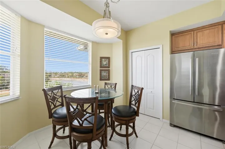 Dining space featuring light tile patterned flooring and baseboards