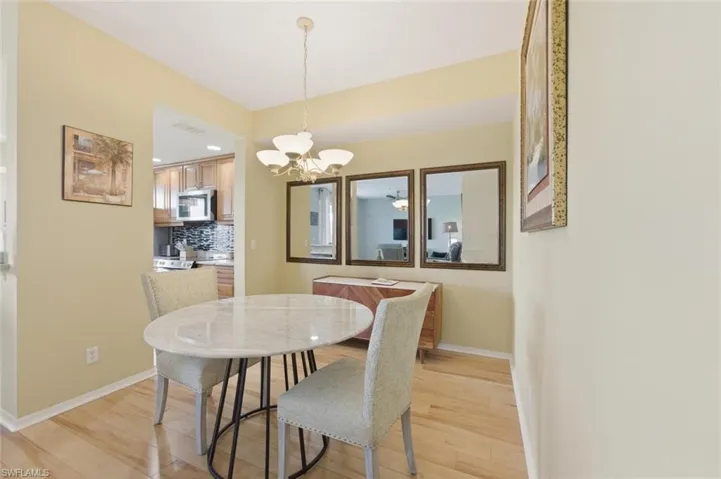 Dining space featuring light wood-style floors and hanging lights