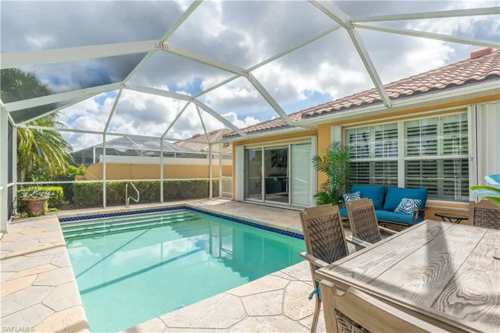 View of swimming pool featuring a lanai, a patio, and an outdoor hangout area
