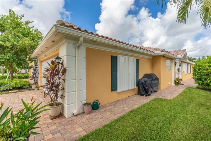 View of property exterior with a lawn and a garage