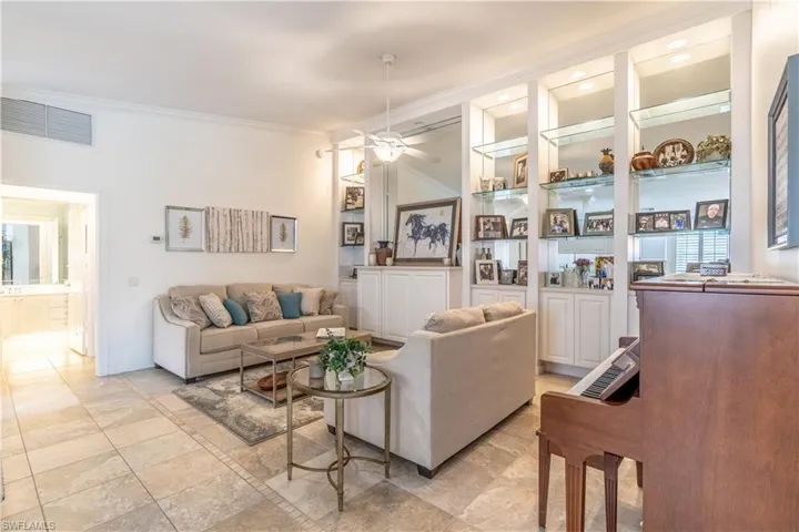 Living room featuring crown molding and ceiling fan