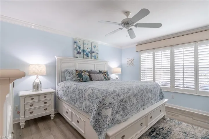 Bedroom featuring crown molding, hardwood / wood-style floors, and ceiling fan