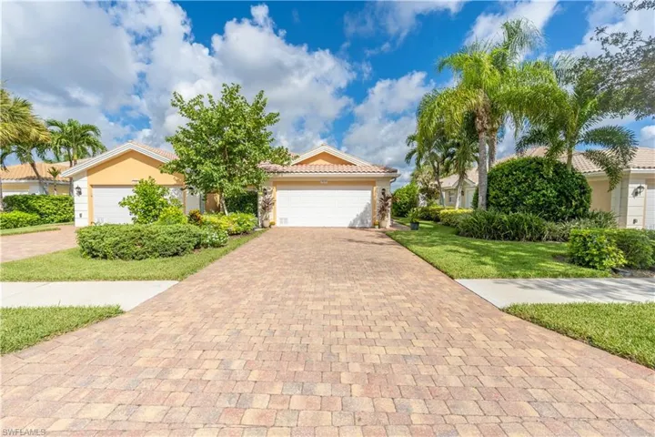 View of front of property featuring a front yard and a garage