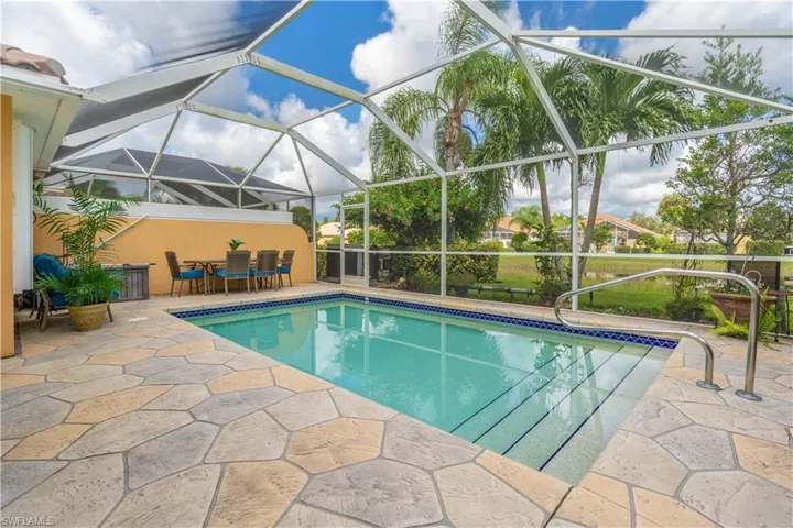 View of pool with a lanai and a patio area