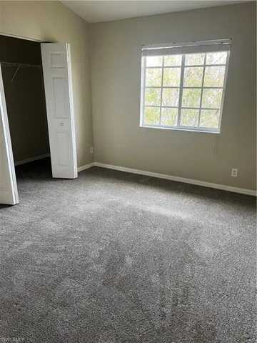 Unfurnished bedroom with carpet floors and a closet