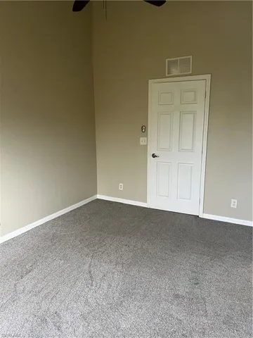 Unfurnished room featuring ceiling fan and carpet floors