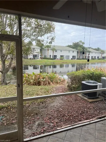 View of yard with central air condition unit and a water view