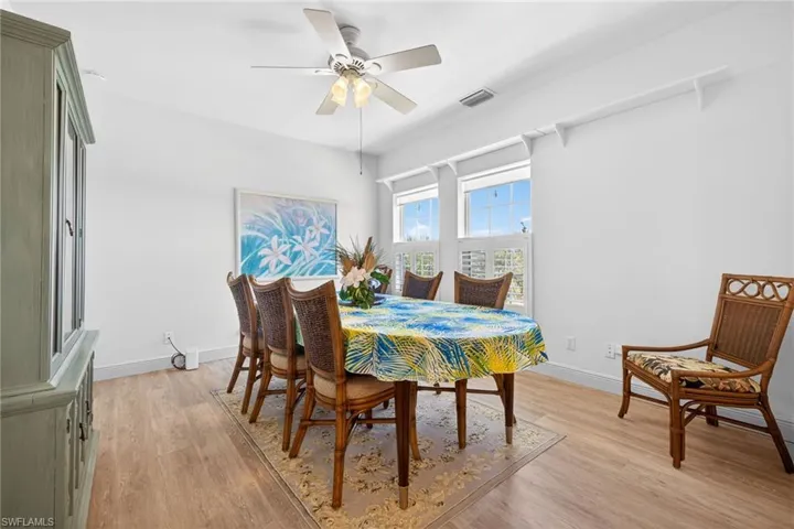 Dining room featuring light wood-type flooring and a ceiling fan
