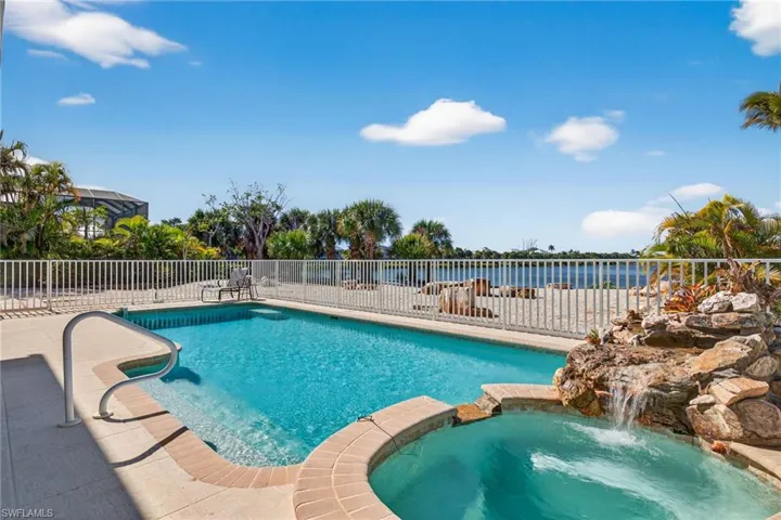 View of swimming pool featuring a pool with connected hot tub and a patio