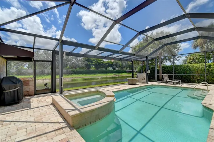 Note the spacious pool/spa screened cage area with a  picture window