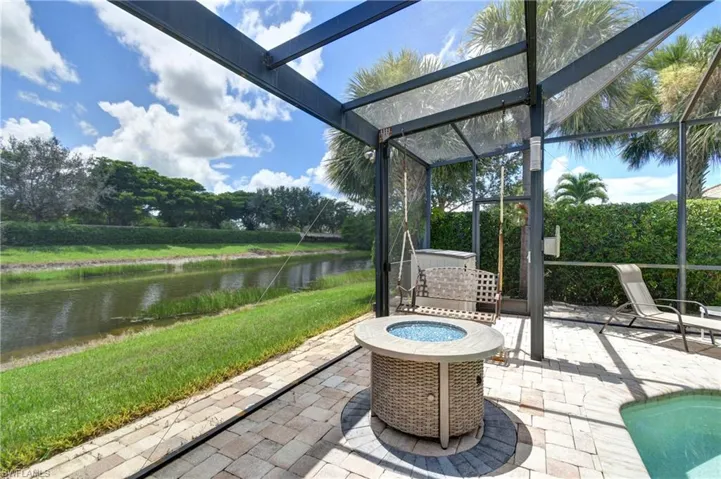 Pool lanai is oversized with room for this fire pit and swing; storage area in the corner for pool equipment, etc