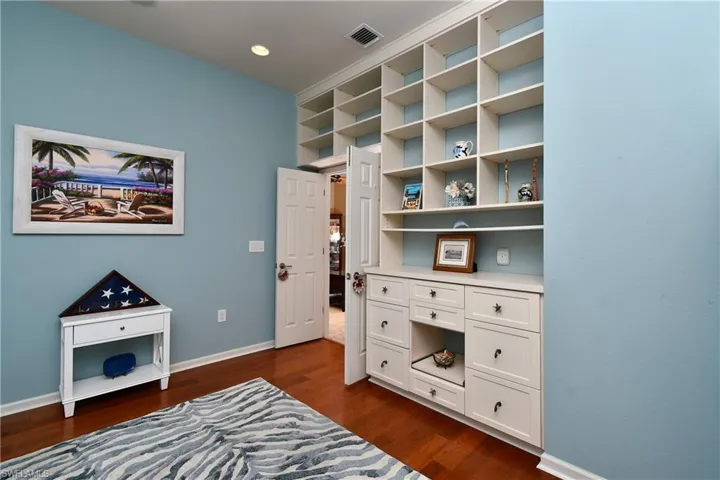 3rd BR with built -in  shelving and drawers on the one wall