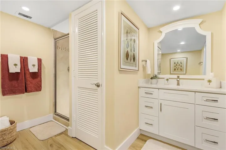 Bathroom with vanity, hardwood / wood-style floors, and walk in shower