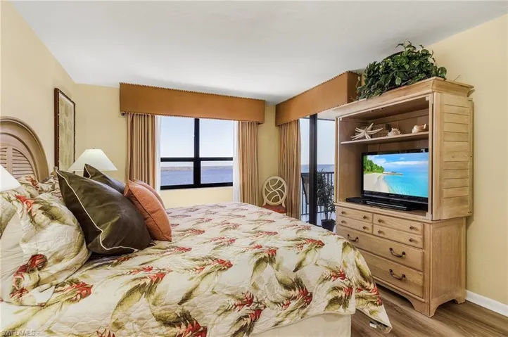 Bedroom with access to exterior and wood-type flooring