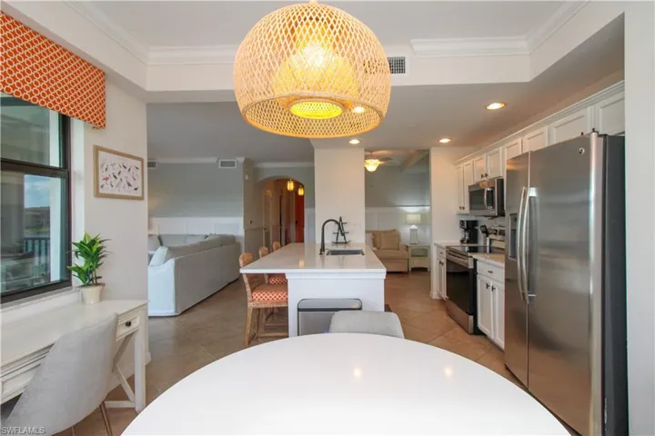 Kitchen featuring crown molding, white cabinetry, sink, and appliances with stainless steel finishes