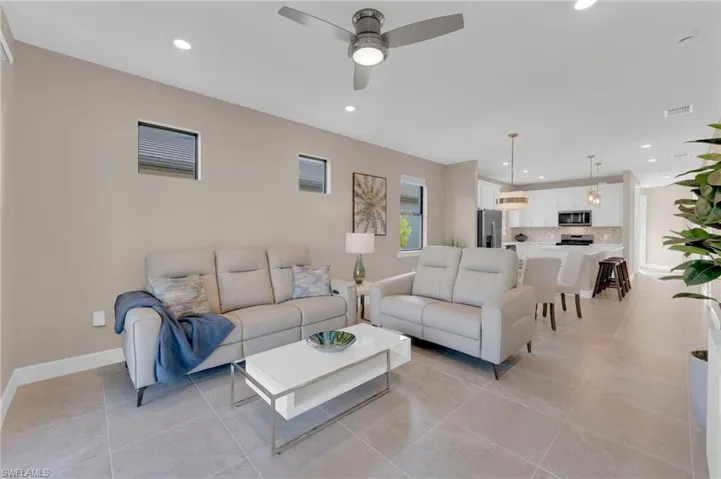 Living area featuring recessed lighting, a ceiling fan, and light tile patterned floors