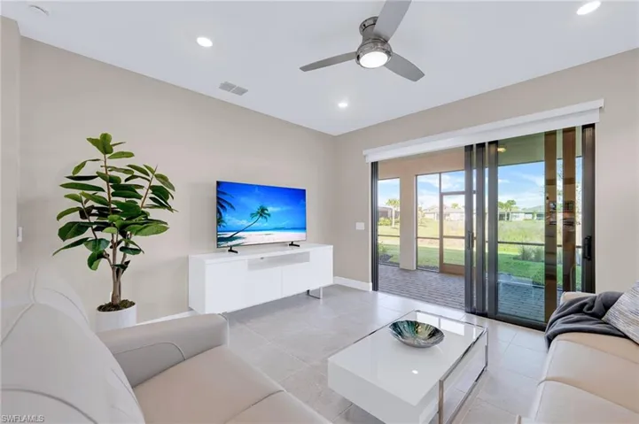 Living room featuring recessed lighting, a ceiling fan, and light tile patterned flooring