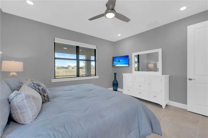 Bedroom featuring a ceiling fan, light tile patterned floors, and recessed lighting