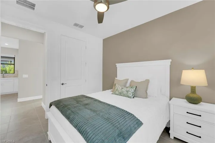 Bedroom with ceiling fan and light tile patterned floors