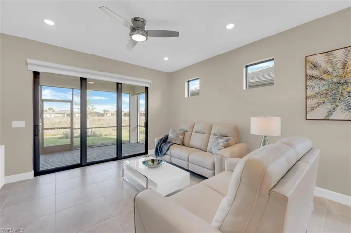 Living room featuring a ceiling fan, light tile patterned floors, and recessed lighting