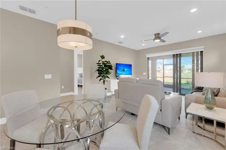 Dining room with ceiling fan, recessed lighting, and light tile patterned floors
