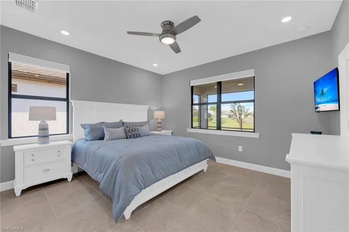 Bedroom featuring a ceiling fan, light tile patterned floors, and recessed lighting