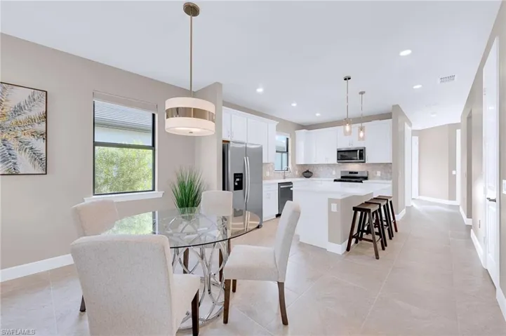 Dining room featuring baseboards and recessed lighting