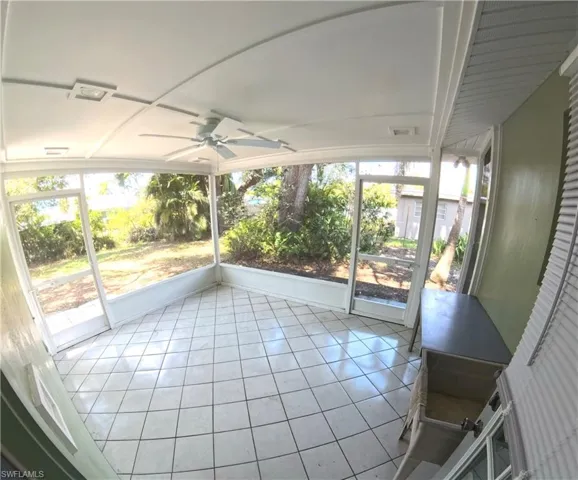 Unfurnished sunroom with a ceiling fan