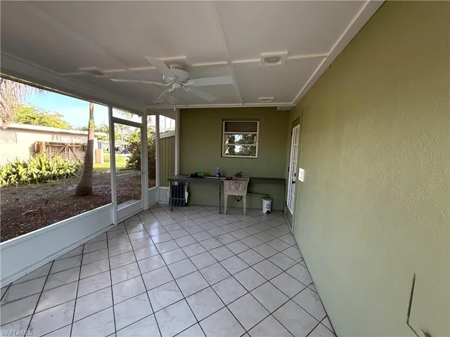 Unfurnished sunroom featuring a ceiling fan