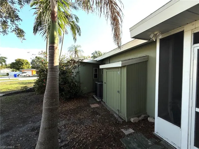 View of home's exterior with a storage shed and a cooling unit