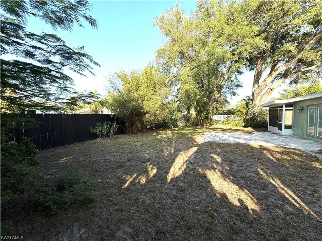Fenced backyard with a sunroom