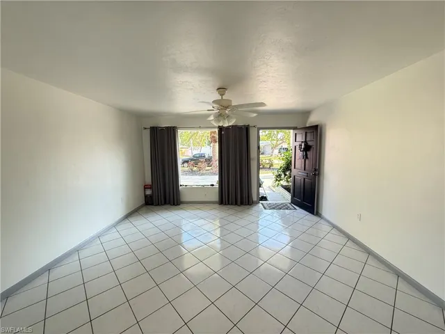 Spare room featuring light tile patterned flooring and a ceiling fan