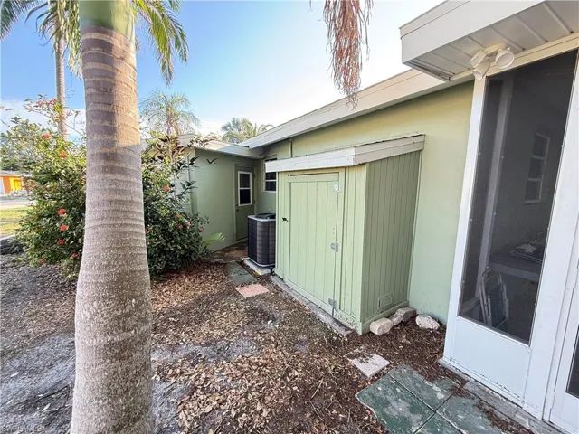View of home's exterior with a storage unit and a central AC unit