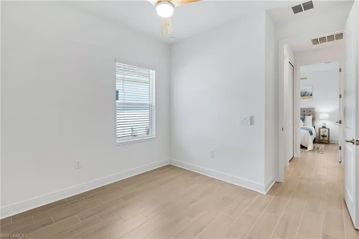 2nd Bedroom with tile flooring, walk in closet and ceiling fan