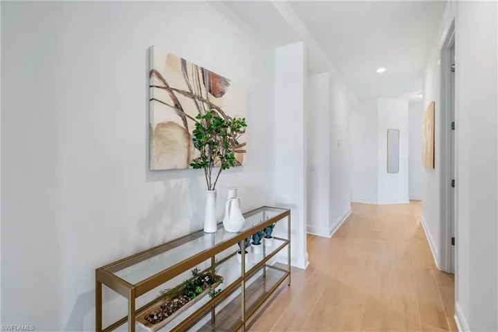 Hallway featuring light hardwood / wood-style  tile floors