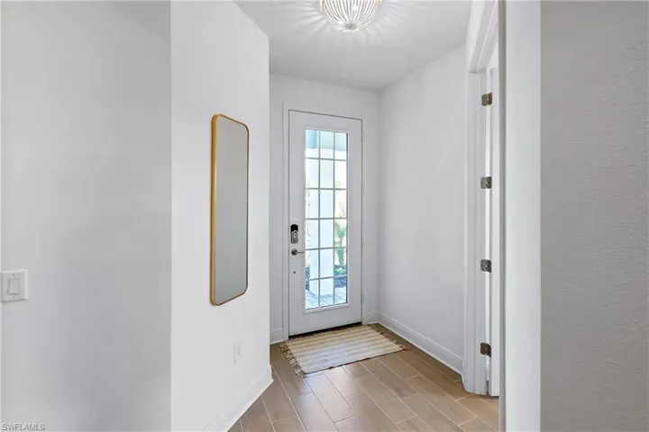Entryway with light Wood-type Tile Flooring throughout the Home