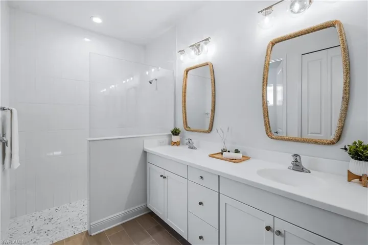 Bathroom with a tile to ceiling shower and dual vanity