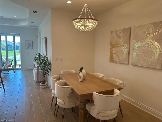 Dining area featuring a chandelier and wood-Tile flooring